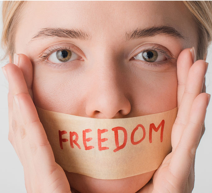woman with tape on her mouth with the word freedom written on it. regain your freedom with mental health counseling in tustin,