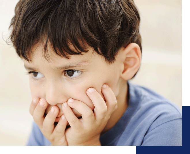 A child watches something with his hands over his mouth and cheeks. This image shows how a child may be feeling before parents go to ADHD counseling in Tustin CA.