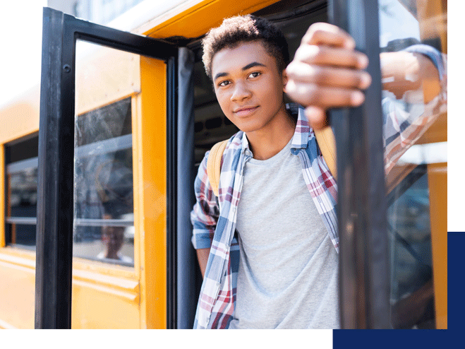 A teen boy smiles as he exits a school bus. This represents how a child can thrive when parents seek ADHD counseling in Tustin CA and coaching to help their kids thrive.